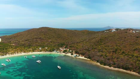 Aerial-view-of-the-pristine-tropical-Salt-Whistle-Bay,-Mayreau-island