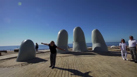 Travelling-The-Hand-Statue-in-Punta-del-Este-with-sea-background
