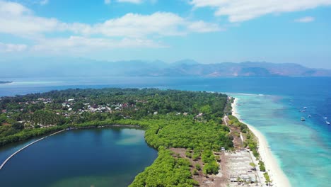 Mangrove-near-tropical-coastline-in-Indonesia-with-lush-vegetation-and-trees-around-white-beach-washed-by-turquoise-lagoon-on-a-bright-cloudy-sky-background