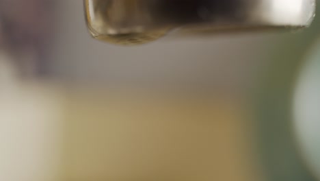 Macro-shots-of-a-dripping-water-faucet-wasting-water