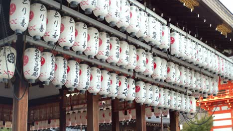 Asian-lanterns-hung-up-outside-early-in-the-morning-in-front-of-a-shrine-in-Kyoto,-Japan-soft-lighting-slow-motion-4K