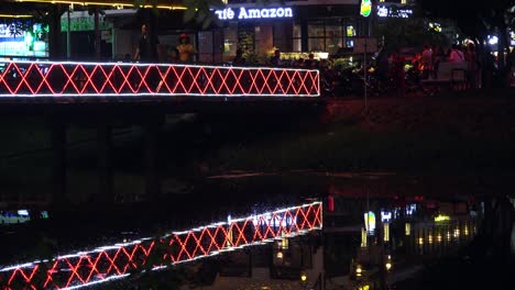 Peoples-Walking-on-an-Illuminated-Bridge