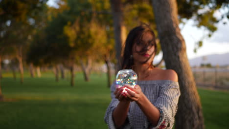A-beautiful-sorcerer-holding-a-magic-glowing-crystal-ball-with-an-enchanting-and-mysterious-look