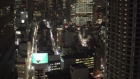 Tokyo-downtown-at-night-with-street-lights-and-modern-towers-in-Japan