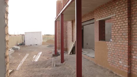 Pan-of-new-house-Construction-with-steel-framing-and-raw-bricks