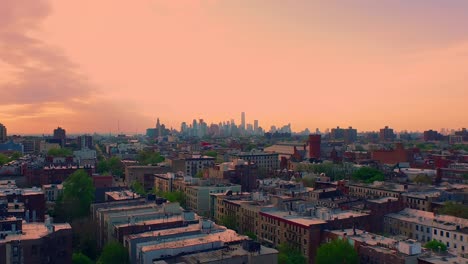Epische-Luftaufnahme-Zur-Goldenen-Stunde-Des-Sonnenuntergangs-über-Den-Dächern-Von-Brooklyn,-Die-In-Richtung-Innenstadt-Von-Manhattan-Fliegt,-4k