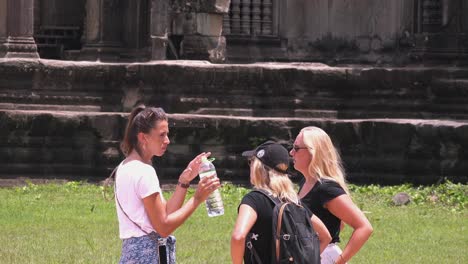 Women-Drinking-Water-at-Angkor-Wat-Temple