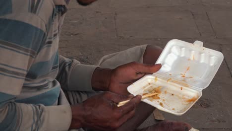 Close-Shot-of-a-Cambodian-Man-Finishing-Eating-from-a-Polystyrene-Container