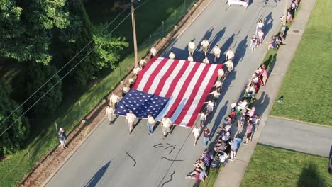 Amerikanische-Pfadfinder-Tragen-Die-Amerikanische-Flagge-Während-Einer-Parade-Zum-Unabhängigkeitstag-In-Einer-Amerikanischen-Kleinstadt
