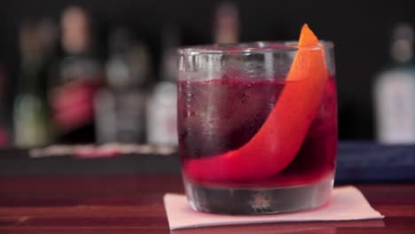 Italian-cocktail-negroni-served-in-a-cold-glass-with-ice-and-orange-skin