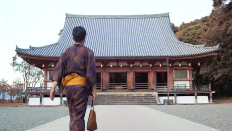 Guy-wearing-a-Yukata-walking-towards-a-temple-to-go-pray-in-Kyoto,-Japan-soft-lighting-slow-motion-4K