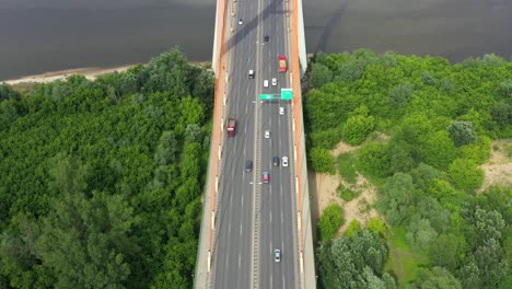 Car-driving-on-highway-bridge-and-road-intersection-in-modern-city-aerial-view