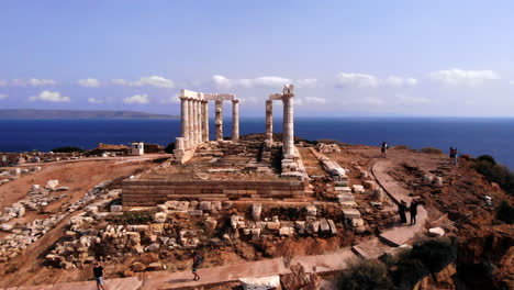 Greek-Temple-of-Poseidon-in-Athens-during-day,-low-rotating-aerial