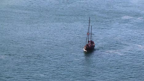 Jolly-Roger-Fliegt-über-Ein-Touristenpiratenboot,-Das-Auf-Besichtigungstour-Geht
