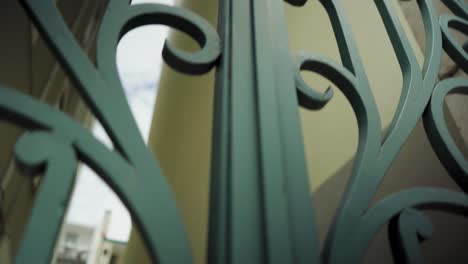 Green-ornate-Iron-gate-with-traveling-camera-in-downtown-4K