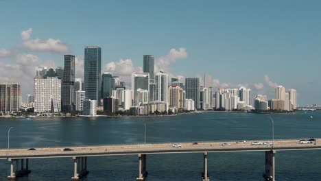 Epic-Aerial-drone-flying-over-bridge---water-towards-downtown-Miami-4k