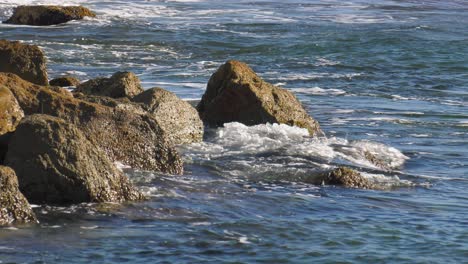 Blue-ocean-waves-crashing-on-rocks,-slow-motion,-spain