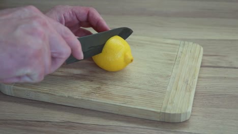 Man-cutting-a-lemon-on-the-chopping-board