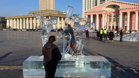 Mother-Watches-Her-Son-Play-On-A-Music-Themed-Ice-Sculpture