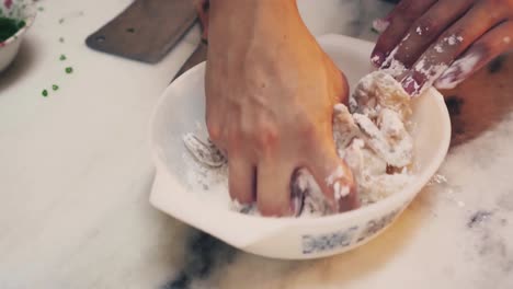 A-chef-mixing-prawn-with-flour-powder-in-a-pan-for-frying-close-up