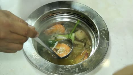 Delicious-Hot-Pot-Soup-In-A-Stainless-Bowl-With-Shrimp,-Vegetables,-And-Corn---Closeup-Shot
