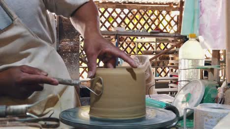 Close-Slow-Motion-Shot-of-a-Craftsman-Creating-a-Pot-on-a-Pottery-Wheel-in-the-Studio