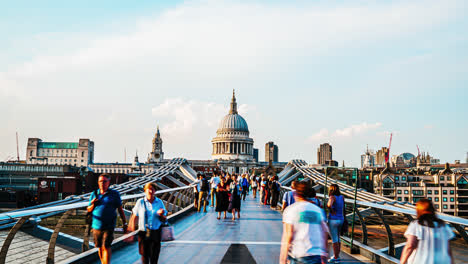 London-England,-circa-:-timelapse-People-walking-over-Millennium-bridge-with-St-Pauls-cathedral-background