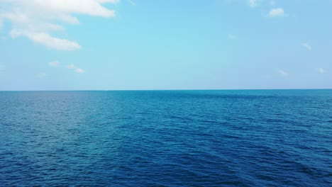 Friedliche-Blaue-Meeresoberfläche-Mit-Vibrierendem-Wasser-Unter-Hellem-Himmel-Mit-Wunderschönen-Weißen-Wolken-An-Der-Küste-Hawaiis,-Kopierraum