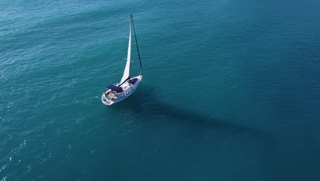 Aerial-shot-for-sailing-boat-with-vail-at-the-sea-with-sunlight-reflections