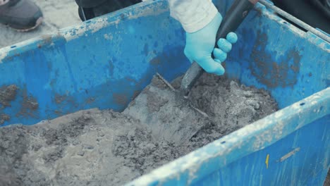 Mixing-cement-in-bucket-with-shovel-SLOW-MOTION