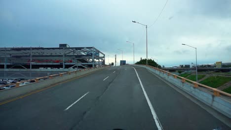 POV-shot-driving-away-from-the-San-Ysidro-border-into-Tijuana,-Mexico,-Rainy-day