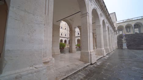 Female-tourist-walking-alone-at-empty-and-desolate-courtyard-at-abbey-of-Montecassino,-Italy,-covid-19-pandemic,-static