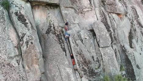 Aerial-shot-approaching-some-climbers-on-a-granite-wall