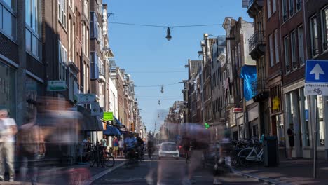 A-timelapse-of-pedestrians-and-bicyclists-moving-along-on-the-Haarlemmerdijk-in-Amsterdam,-the-Netherlands