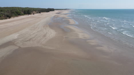 Slow-drone-shot-moving-from-the-water-towards-beach-at-Lee-Point-in-Northern-Territory