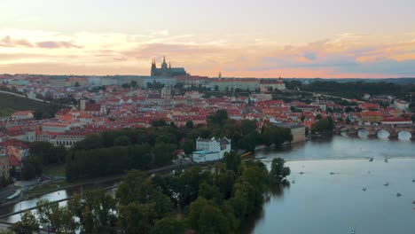Aerial-View-Of-Prague-old-City-center-During-Golden-Orange-Sunset-With-Prague-Castle-and-Vltava-river