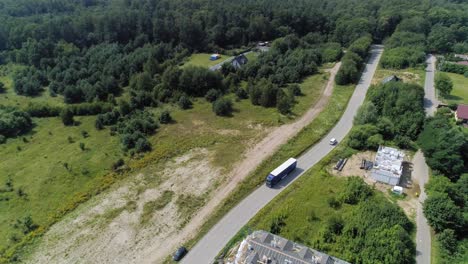 Trailer-Truck-Driving-On-The-Road-In-Kowale,-Gdansk-County,-Poland-On-A-Sunny-Day---aerial-shot