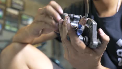 Close-up-Footage-of-The-Technician-Working-On-Motorcycle-Brake-Caliper-Cleaning-Process