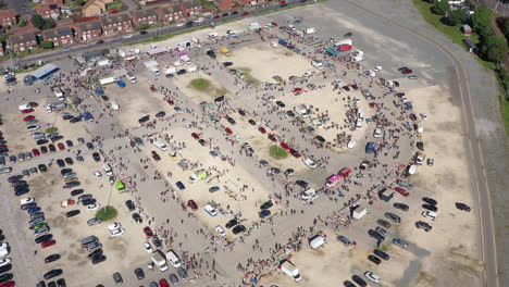 Floating-high-aerial-drone-shot-towards-a-busy-market-and-car-boot-sale-in-Hull-England-UK