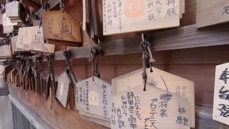Japanese-Ema-hanging-at-a-shrine-with-prayers-or-wishes-of-religious-people-written-on-them