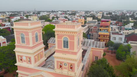Top-Angle-Close-Up-Orbital-Aerial-Shot-of-Our-Lady-Angeles-Church-on-a-Cloudy-morning-near-the-french-town,-Puducherry-shot-with-a-drone-in-4k
