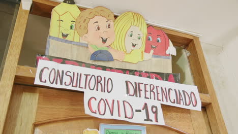 A-sign-outside-a-consultation-room-dedicated-to-Covid-19-patients-during-the-pandemic-in-Ollantaytambo,-Peru