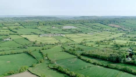 Aerial-shot-over-a-vast-area-of-green-fields-in-rural-Britain
