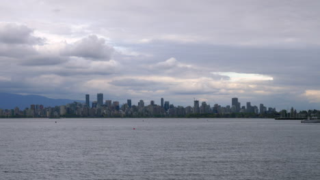 Calm-Ocean-With-Downtown-Skyline-And-Vancouver-Harbour-On-The-Background,-View-From-Burnaby,-BC,-Canada-On-A-Cloudy-Day
