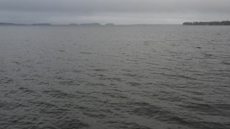 Low-flyover-of-lake-water-on-a-foggy-morning