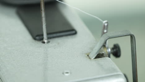 Heavy-Duty-Sewing-Machine-Working-On-Isolated-Background--Closeup-Shot