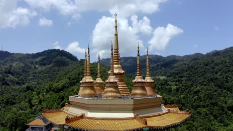 Roof-spires-on-the-roof-of-Kuan-Yin-shrine-inside-Kek-Lok-Si-Buddhist-temple-seen-from-the-side,-Aerial-drone-reveal-shot