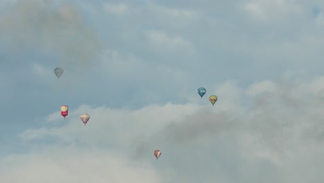 Six-colored-hot-air-balloons-are-high-in-the-sky-between-the-clouds