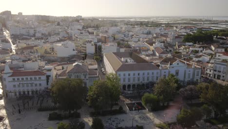 Drone-Flies-over-amazing-Traditional-European-cityscape-of-Faro-in-Portugals-Algarve-region-during-sunset,-aerial
