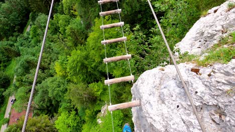 Am-man-walking-on-a-suspension-bridge-made-out-of-pieces-of-wood